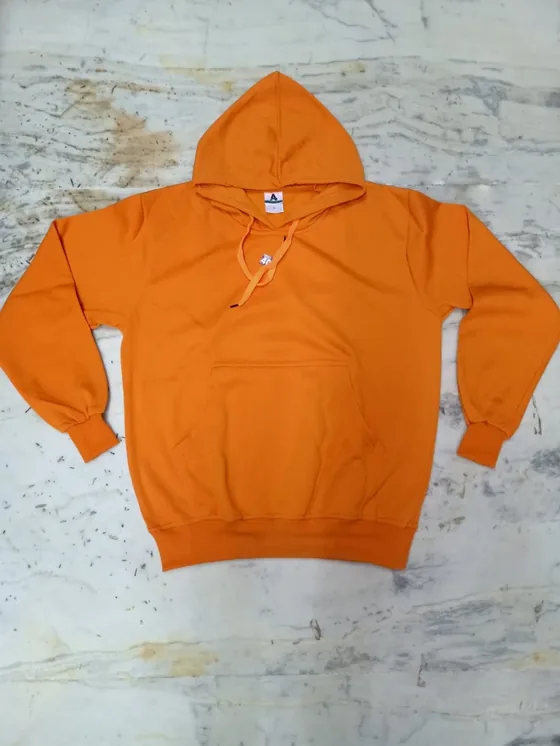 Phone photo of an orange hoodie laid flat on the floor